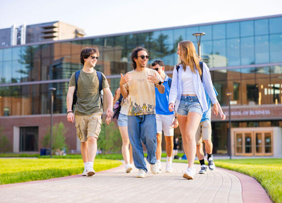 Students walking through the quad with South Quad in the background