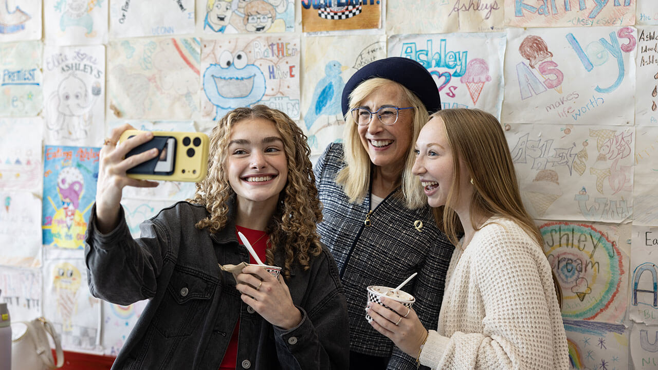 Students smile for photo with President Marie C. Hardin